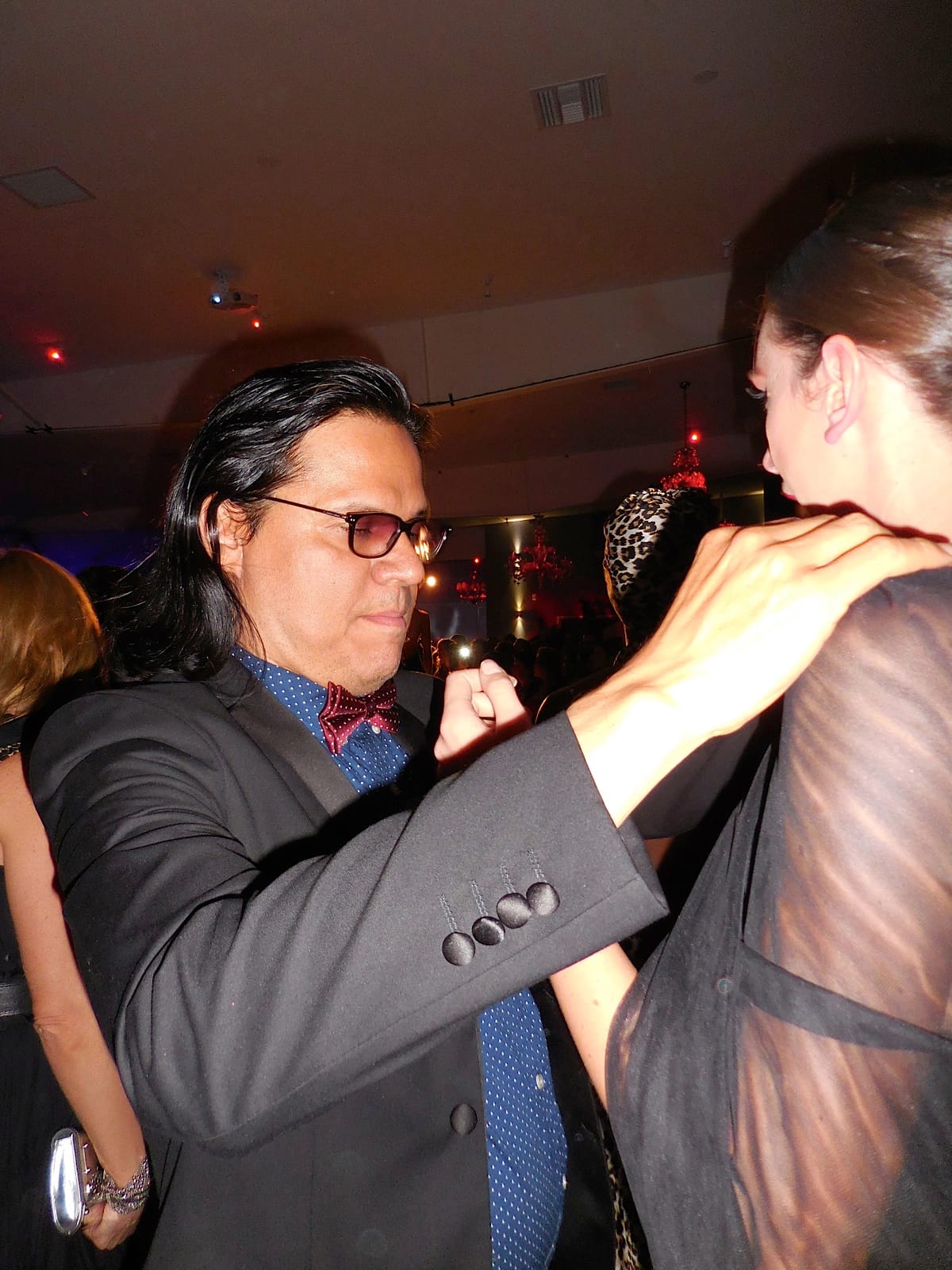 Designer Xavier Othon makes a last minute adjustment to his model's outfit before her catwalk.