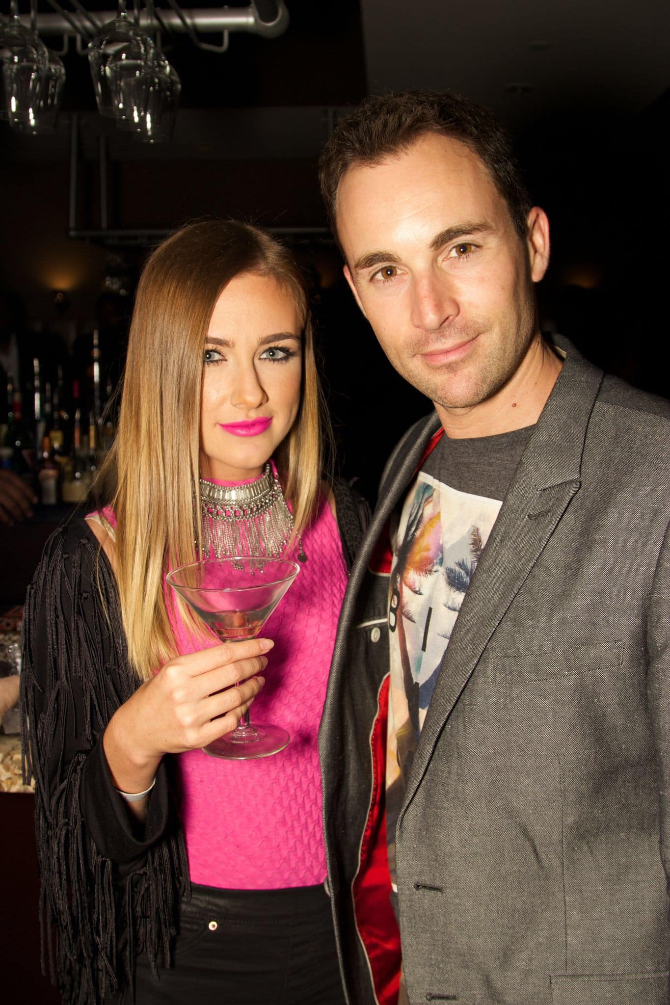 A young couple enjoys a cocktail at the PASH party in Beverly Hills