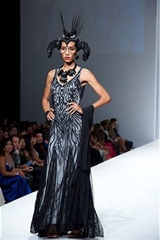 A model dressed as a siren in dark lace and a beguiling headdress wows the crowd. Photo courtesy of Earl Gibson III/Wireimage