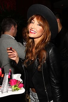 Actress Fernanda Romera tries out a lipstick from the Aniise by Patricia De Leon line. Photo courtesy of Paul Redmond/Wireimage
