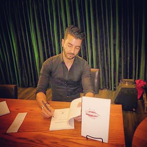 Dr. Pedram Navab signs copies of his book for attendees. Photo courtesy of EE World News