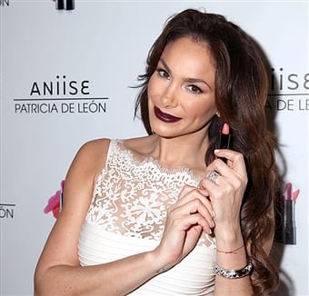 Actress Patricia De Leon with one of the lipsticks from her new line on the red carpet. Photo courtesy of Paul Redmond/Wireimage