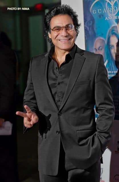 Madadian makes a peace sign for his fans