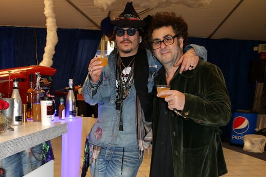 Actor/ musician Johnny Depp (L) of The Hollywood Vampires and musician Bruce Witkin enjoying beverages made by the Natural Mixologist at the GRAMMY Gift Lounge during The 58th GRAMMY Awards at Staples Center on February 13, 2016 in Los Angeles, California. (Photo by Imeh Akpanudosen/WireImage)
