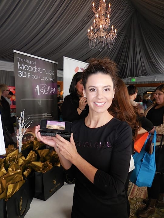 Jill blissfully holds up the Younique 3D fiber lashes product