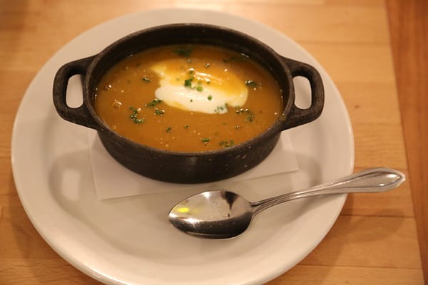 The butternut squash soup served in Status Kuo's signature style