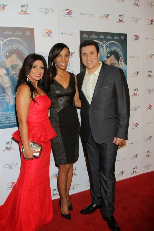 From left to right: Pirhamzei's wife lights up the red carpet in a red ballgown, Robinson and Pirhamzei