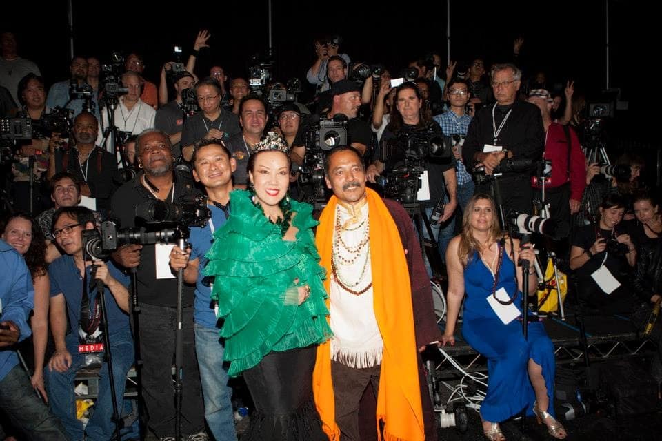 Sue with Master Romio by a wall of acclaimed fashion and celebrity photographers getting ready to shoot the catwalk of her amazing runway show